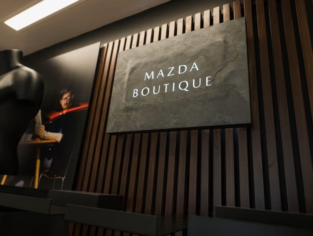 A wall display labeled “Mazda Boutique” with a textured sign