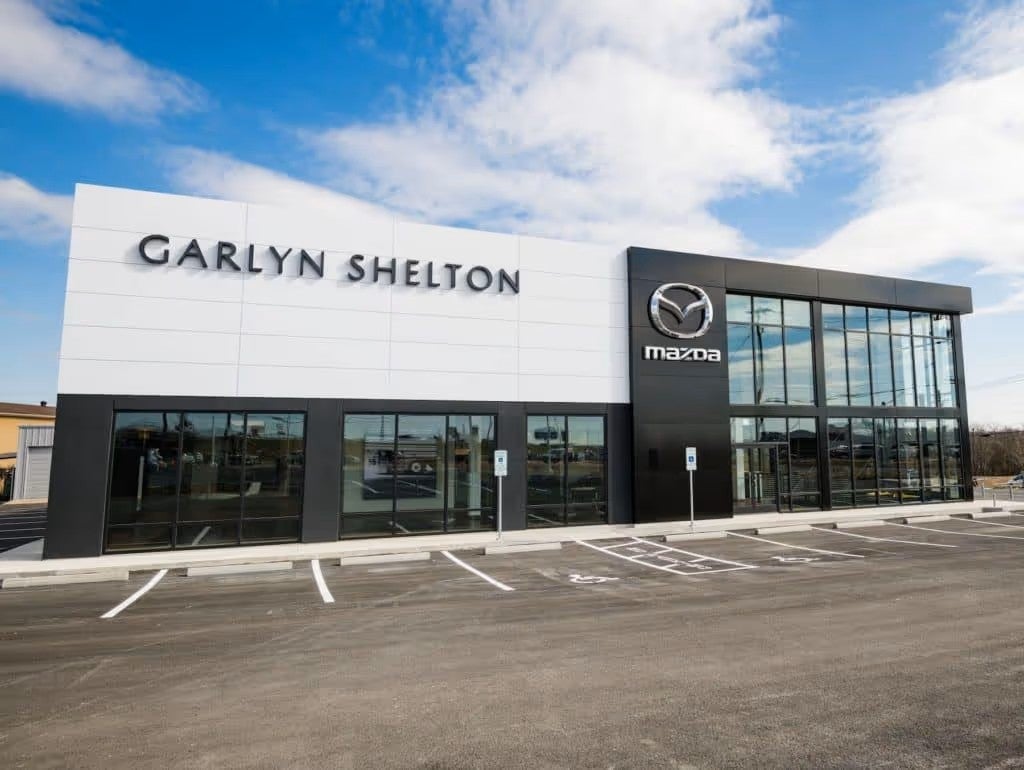 Exterior view of a Volkswagen dealership building with large glass windows